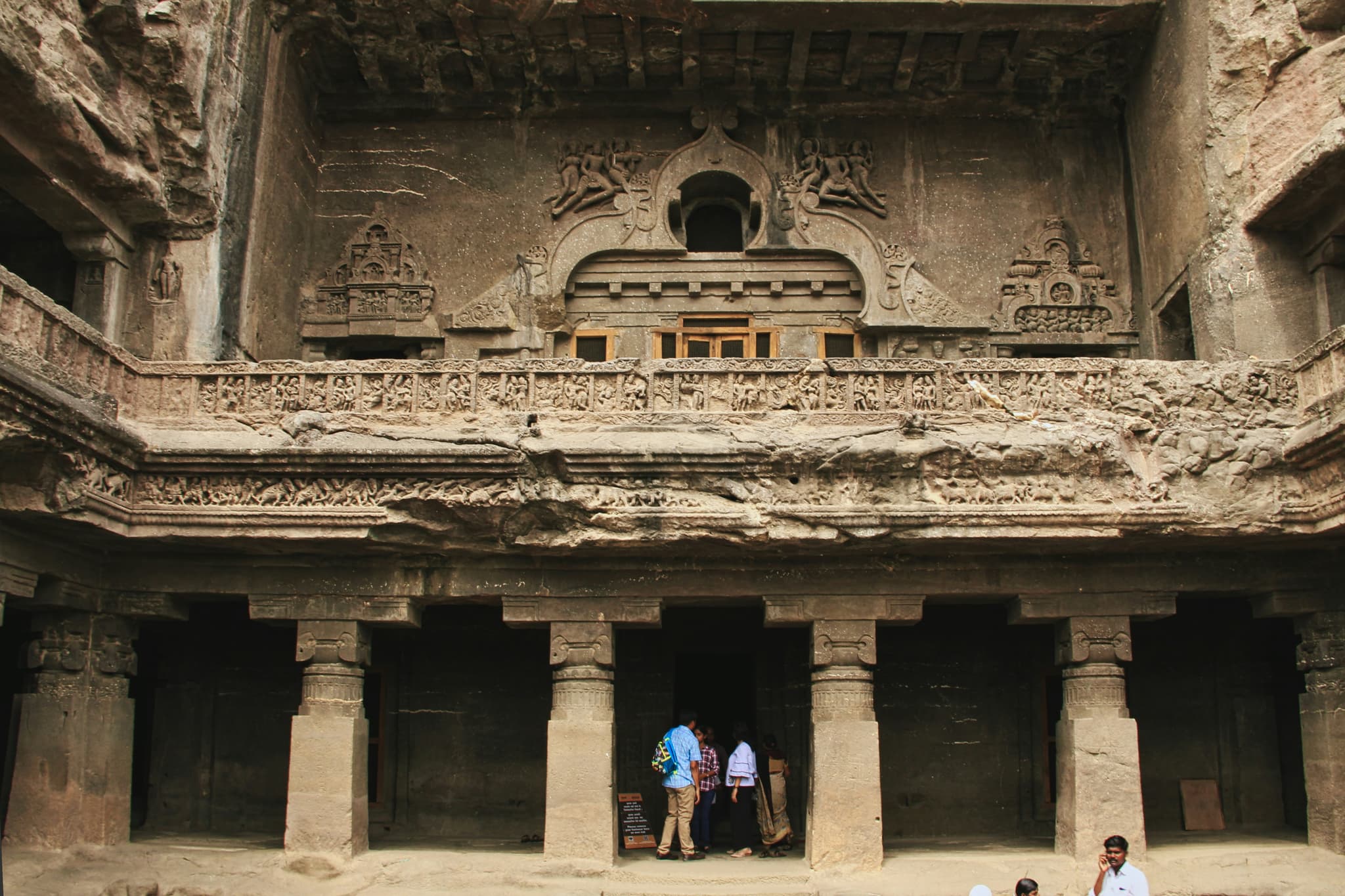 One of the many entrances of the cave temple at Ellora caves, beautifully decorated with intricated stone carvings.